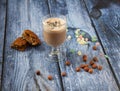 Closeup shot of a glass of cappuccino with cake