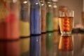 Closeup shot of a glass of classic cocktail on a glass table on a blurred background