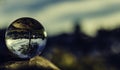 Closeup shot of a glass sphere reflecting its surroundings within itself Royalty Free Stock Photo