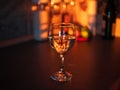 Closeup shot of a glass of white wine on the table on the background of bottles and fruits Royalty Free Stock Photo