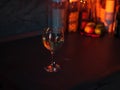 Closeup shot of a glass of white wine on the table on the background of bottles and fruits Royalty Free Stock Photo