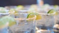 Closeup shot of glasses of alcoholic drinks with limes on top