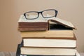 Closeup shot of glasses on the stack of old dusty books