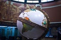 Closeup shot of the Globe in Los Angeles Time building with a mural in the background