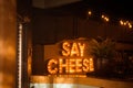 Closeup shot of a glowing illuminated Say Cheese sign