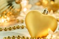 Closeup shot of golden heart-shaped Christmas ornaments placed on a white surface