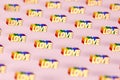 Closeup shot on Golden LOVE word with rainbow outline pattern. June as a month of gay pride and love concept. on pink