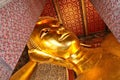 Closeup shot of the golden statue of Buddha in Wat Pho Buddhist temple complex, Thailand Royalty Free Stock Photo