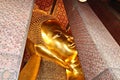 Closeup shot of the golden statue of Buddha in Wat Pho Buddhist temple complex, Thailand Royalty Free Stock Photo