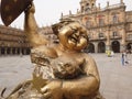 Closeup shot of a golden statue of a happy woman in the big square in the center of Salamanca, Spain