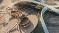 Closeup shot of golden wedding rings attached to a brown heart-shaped textile Royalty Free Stock Photo