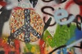 Closeup shot of a graffiti and peace sign mosaic at the John Lennon Wall in Prague, Czech Republic Royalty Free Stock Photo
