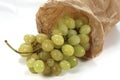 Closeup shot of grapes in a paper bag on a white background Royalty Free Stock Photo