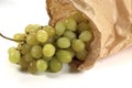 Closeup shot of grapes in a paper bag on a white background Royalty Free Stock Photo