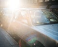 Closeup shot of a gray parked car with the sunlight over it