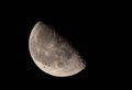 Closeup shot of a gray textured half moon in a dark sky Royalty Free Stock Photo