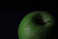 Closeup shot of a green apple on a black background Royalty Free Stock Photo