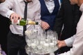 Closeup shot of a groom and best men pouring champaign