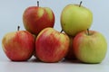 Closeup shot of a group of apples on a blue background.