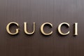 Closeup shot of Gucci logo written on a dark brown wall in San Francisco city center, California