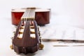 Closeup shot of guitar fingerboard and sheet with notes. Royalty Free Stock Photo