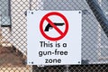 Closeup shot of a gun-free zone sign on a fence