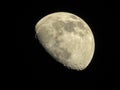 A closeup shot of a half moon with dark skies and so star Royalty Free Stock Photo