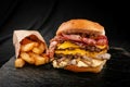 Closeup shot of a hamburger and frie on an isolated black background