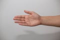 Closeup shot of a hand for a handshake symbol on a white background
