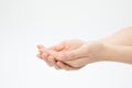 Closeup shot of hands in a begging gesture isolated on a white background