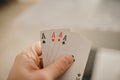 Closeup shot of hands holding playing cards Royalty Free Stock Photo