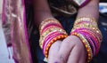 Closeup shot of hands of Indian female wearing colorful bangles