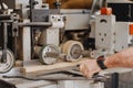 Closeup shot of hands operating an industrial wood smoothening machine Royalty Free Stock Photo