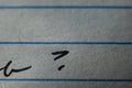 Closeup shot of a handwritten text with a question mark in a piece of paper
