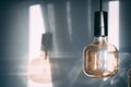 Closeup shot of hanging illuminated glowing artistic lightbulbs