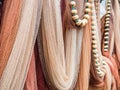 Closeup shot of hanging multicolored fishing nets and white beads on a green rope Royalty Free Stock Photo