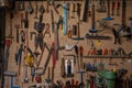 Closeup shot of hanging tools on a brown storage board