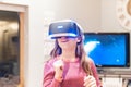 Closeup shot of a happy little smiling girl living through unbelievable emotions with VR glasses