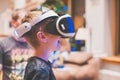 Closeup shot of a happy smiling male child experiencing unbelievable emotions with VR glasses