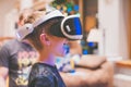 Closeup shot of a happy smiling male child experiencing unbelievable emotions with VR glasses