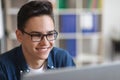 Closeup Of Smiling Young Man In Glasses Working With Laptop In Office Royalty Free Stock Photo