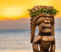 Closeup shot of the Hawaiian tiki statue sunrise with the ocean in the background Royalty Free Stock Photo