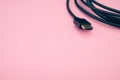 Closeup shot of HDMI cable isolated on a pink background