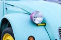 Closeup shot of headlight of blue vintage car