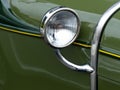 Closeup shot of the headlight of a green vintage car Royalty Free Stock Photo
