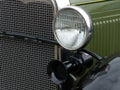 Closeup shot of a headlight and a horn of an old vintage green car Royalty Free Stock Photo