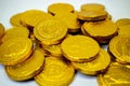 Closeup shot of a heap of gold coins on white background