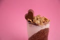 Closeup shot of heart-shaped chocolate on top of cocoa chia pudding with yogurt and cereals Royalty Free Stock Photo