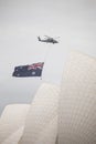 Closeup shot of a helicopter flying the Australian Flag over the Sydney Opera House in Sydney