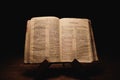 Closeup shot of a historic old Bible open on the Nehemiah pages on display in a dark room Royalty Free Stock Photo